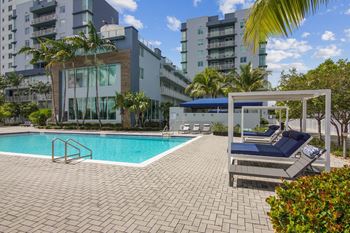 Lakeside pool with jacuzzi, sun deck and private cabanas